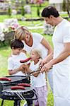 Family with children does barbecue