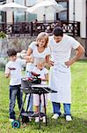 Happy family with barbecue outdoors