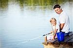 Father and daughter fishing on the lake