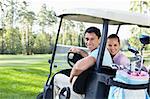 Young couple in the car for golf