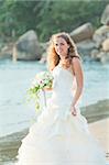 Bride with bouquet on the beach. Tropical wedding