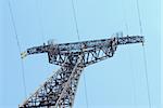 High voltage Electricity pylon against blue sky