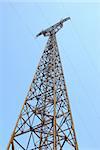 High voltage Electricity pylon against blue sky