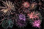 Colorful fireworks of various shapes over black night background