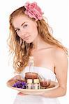 Woman with pink flower and spa products over white
