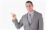 Young businessman pointing at something against a white background