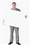 Portrait of a businessman holding a blank panel against a white background