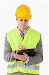 Portrait of a young builder taking notes against a white background