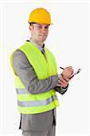Portrait of a smiling builder holding a clipboard against a white background