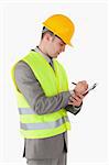 Portrait of a builder taking notes against a white background