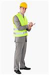 Portrait of a smiling contractor taking notes against a white background