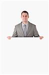 Portrait of a businessman behind a blank panel against a white background