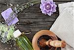 Lavender spa with essential oil over wooden background