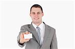 Smiling businessman showing a blank business card against a white background
