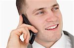 Close up of a handsome entrepreneur making a phone call against a white background