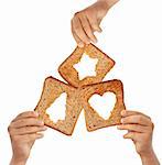 Kids hands holding bread with christmas symbols - love and sharing concept