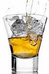 Pouring whiskey on the rocks in a glass