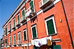 Detail of an ancient red house with a blue sky background in Procida Isle, Italy