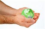 Masculine hands holding a 3d planet globe against a white background