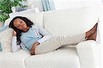 Young woman on sofa putting her feet up
