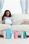 Young woman on sofa checking her shopping