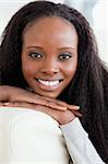 Close up of smiling young woman lying on the sofa