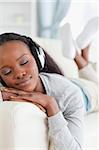 Close up of young woman enjoying music on couch
