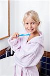 Girl brushing teeth in the bathroom
