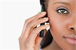 Close up of young woman on the cellphone on white background