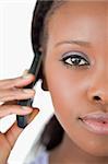 Close up of young woman on the mobile phone on white background