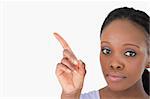 Close up of young woman showing something next to her on white background