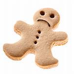 Homemade Gingerbread man cookie with a sad expression isolated on white background