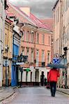 Vilnius oldtown street in a rainy day. Two people - motion blur