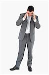 Businessman having a headache against a white background