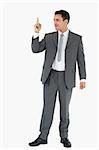 Businessman pointing up against white background