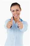 Smiling businesswoman giving her approval against a white background