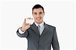 Young businessman showing his businesscard against a white background