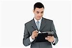 Businessman writing on clipboard against a white background