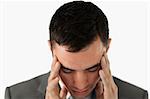 Close up of businessman having a headache against a white background