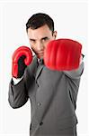 Close up of boxing businessman against a white background