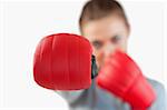 Close up of boxing close used by businesswoman against a white background