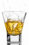 Ice cubes splashing into a glass of whiskey