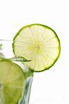 Green mojito with a slice of lime isolated on white