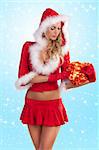 very sexy and attractive blond girl in red santa claus costume keeping a red gift box over white