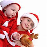 two boy in Santa costumes together