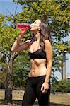 Young female drinking after running