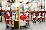 Santa clauses in the line for the sacks of gifts in storehouse