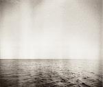 Designed retro photo. Abstract seascape. Grain, dust added as vintage effect.