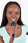 Close up of brightly smiling female singer against a white background