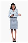 Portrait of a surprised businesswoman reading a text message against a white background